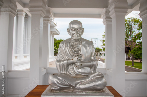 Praying silver monk statue at the Wat Khao Din Temple, Pattaya District, Chonburi, Thailand photo