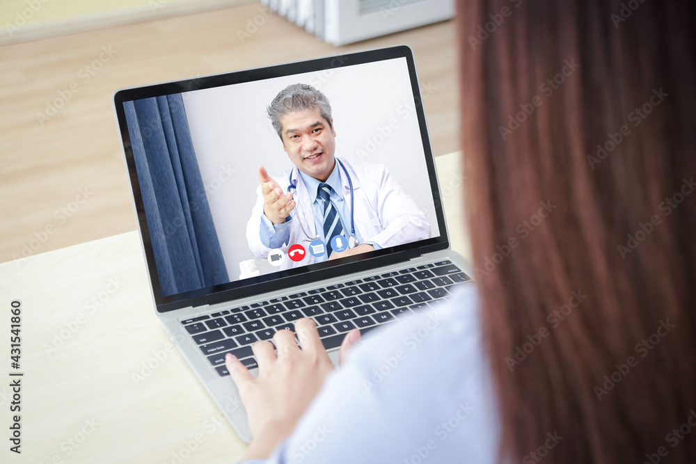 Online doctor concept Monitor patient health through a laptop connected to communication via online technology. The doctor can examine the patient via video call. Hospital services Online doctor concept Monitor patient health through a laptop connected to communication via online technology. The doctor can examine the patient via video call. Hospital services