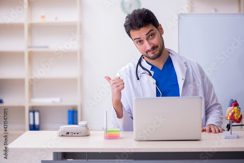 Wallpaper Mural Young male doctor cardiologist in the classroom Torontodigital.ca