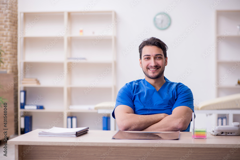 Young male doctor working in the clinic Young male doctor working in the clinic