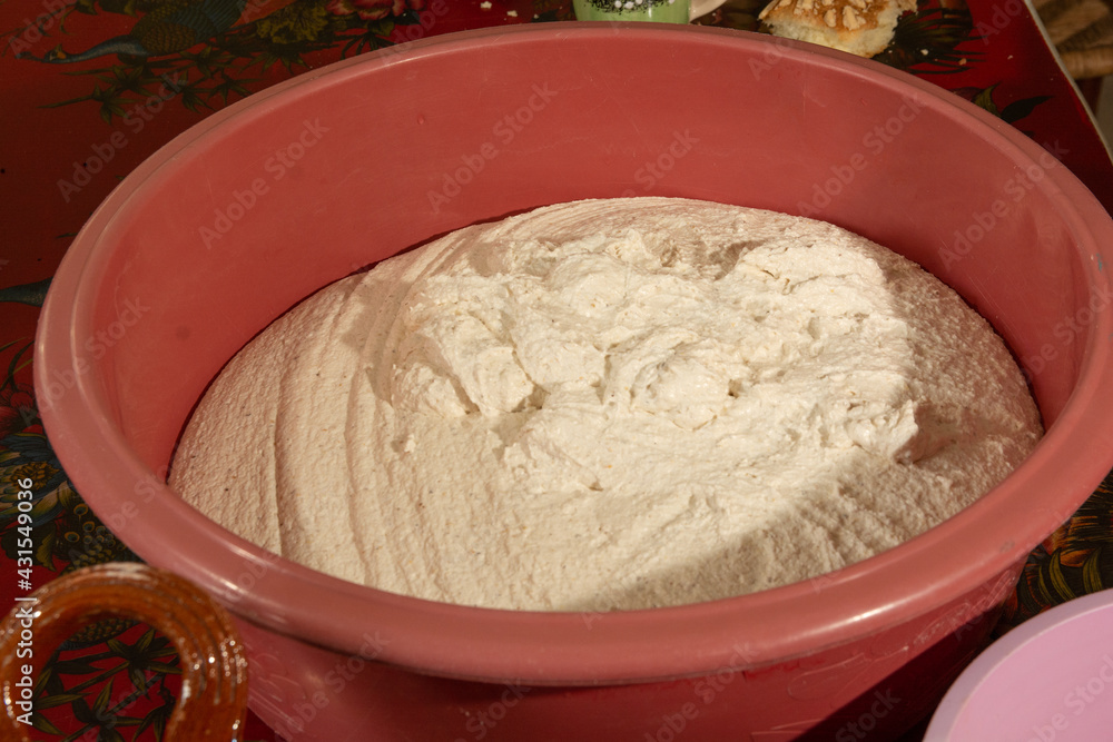 Dough for tamales on a plastic container, tamales are a traditional Mexican food. Dough for tamales on a plastic container, tamales are a traditional Mexican food.