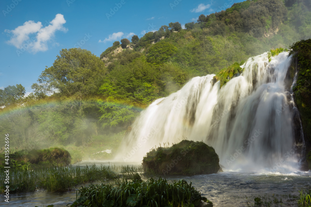 Fototapeta premium Marmore waterfall on a sunny day with rainbow, Valnerina, Nera river park, Umbria, Italy, Terni
