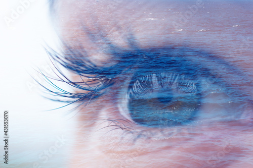 Double exposure with macro feminine blue eye and calm wavy water of ocean or sea. Concept of hopefullness and faith, lost, harmony and tranquility. photo