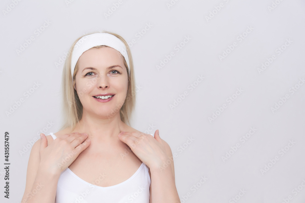 middle-aged woman makes self-massage of the face, neck and decollete middle-aged woman makes self-massage of the face, neck and decollete