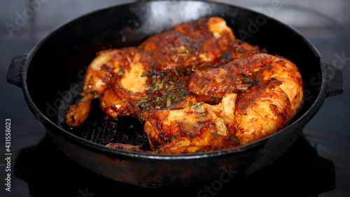 Appetizing grilled chicken in a cast iron pan.