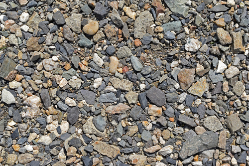 Large colorful pebbles and stones on the river bank