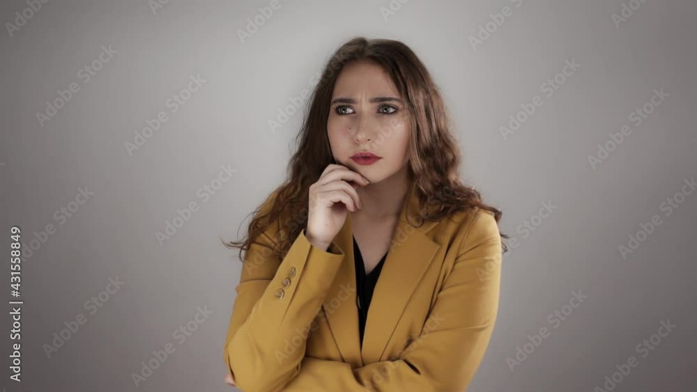 Portrait of a thoughtful woman who came up with solution to problem and became joyful. A young caucasian lady with long hair is pondering on question and find answer. A change of mood in slow motion. Portrait of a thoughtful woman who came up with solution to problem and became joyful. A young caucasian lady with long hair is pondering on question and find answer. A change of mood in slow motion.