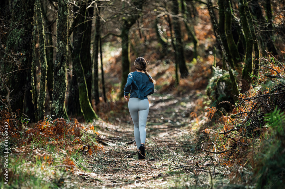 Sporty woman running in forest Sporty woman running in forest