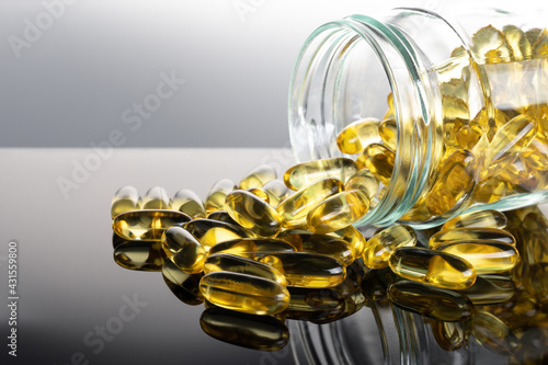 Omega 3 fish oil capsules out open container