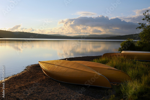 Yellow Canoes on the shore of a lake in early morning Algonquin Park