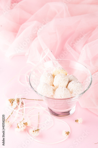 Delicious delicate candies in a glass candy bowl on a pink