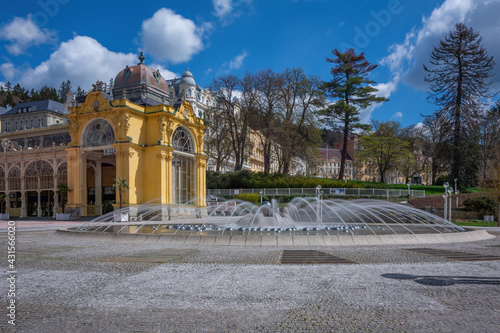 Spring sunny day on the main colonnade with a singing fountain in the center of the Czech spa town of Marianske Lazne (Marienbad) - in the background Goethe Square