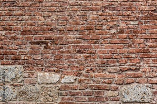 Old  grungy  retro  grimy  brick  wall  of  ancient  city.  Uneven  dirty  pitted  peeled  surface  brickwork  of  cellar  worn.  Ruined  solid  bumpy  stiff  blocks.  Hard  messy  ragged  holes  brickwall  for  3D  grunge  design