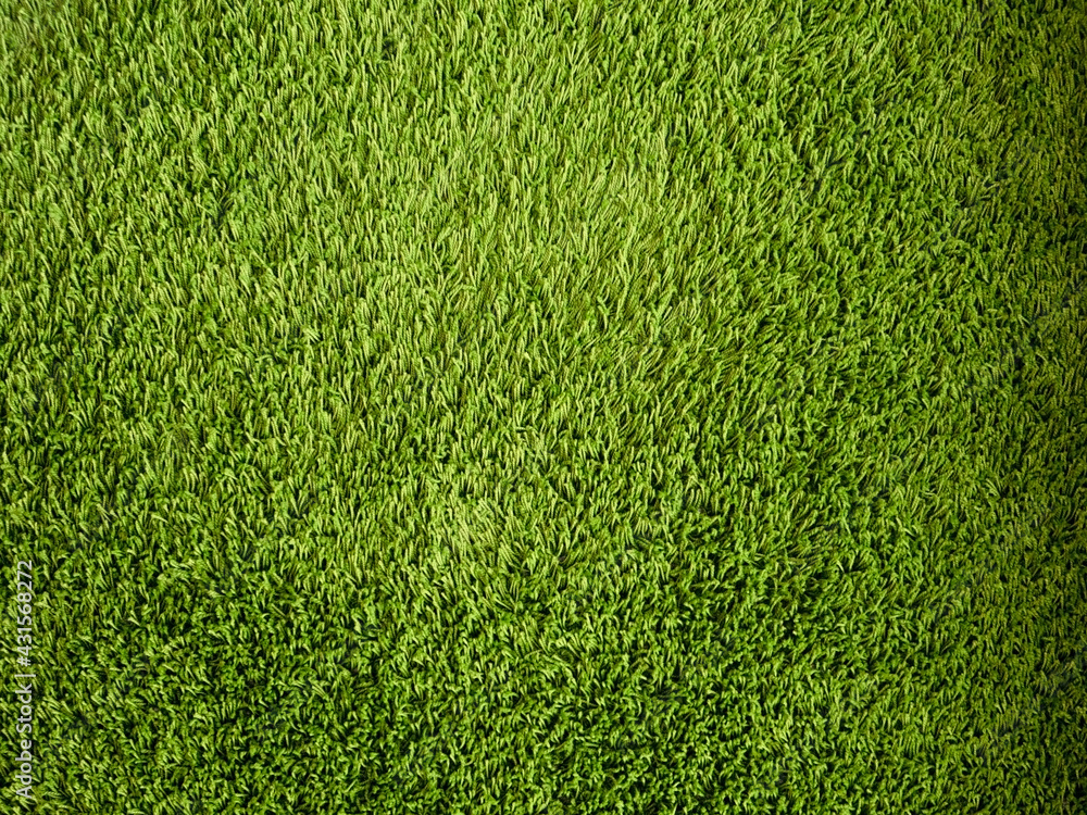 Obraz premium Green background made of artificial threads. Green fabric texture and pattern for background.