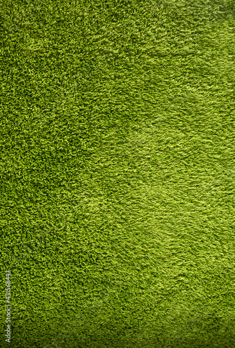 Green background made of artificial threads. Green fabric texture and pattern for background.
