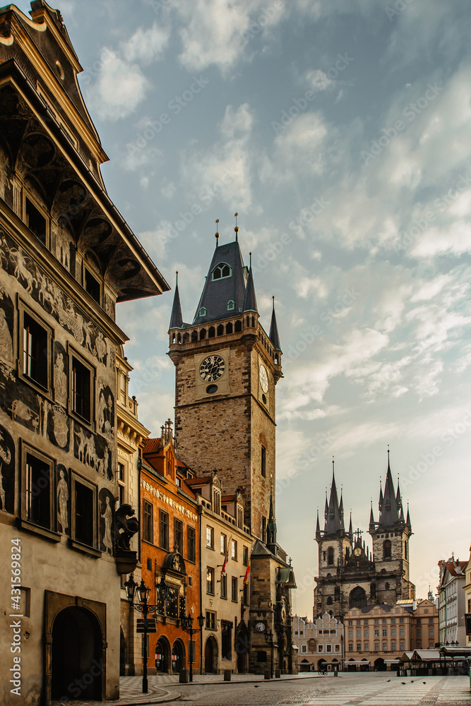 Old Town Square in Prague, Czech Republic. Empty city during sunrise without people surrounded by historical, gothic style buildings and the famous Astronomical Clock Tower.Beautiful urban scene.