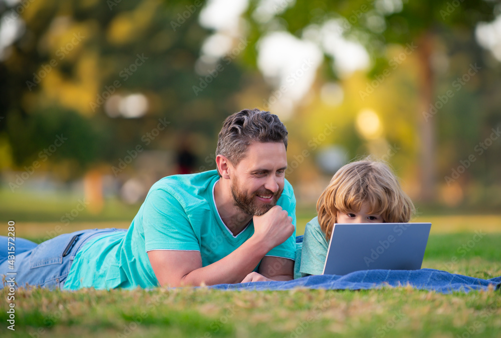 Father teaching son to use laptop, dad and school boy child looking computer screen and tablet. Father teaching son to use laptop, dad and school boy child looking computer screen and tablet.