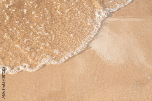 foamy sea water on the beach  golden sand    sun