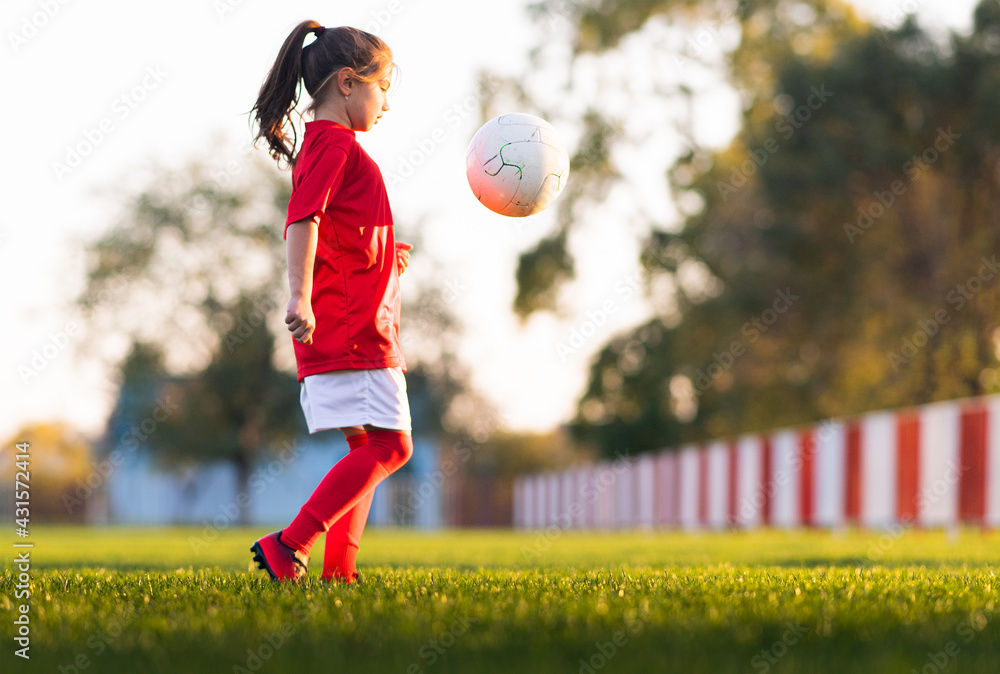 Little girl kicks soccer ball Stock Photo Adobe Stock