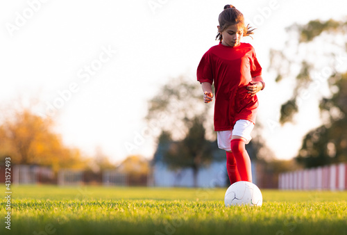 Little girl kicks soccer ball © Dusan Kostic
