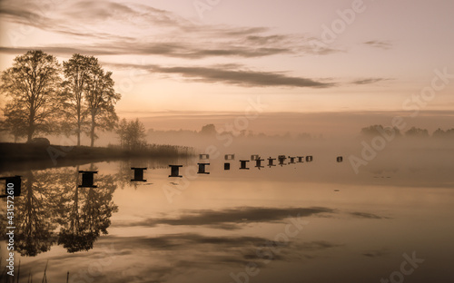 unset on the lake in the evening with fog.