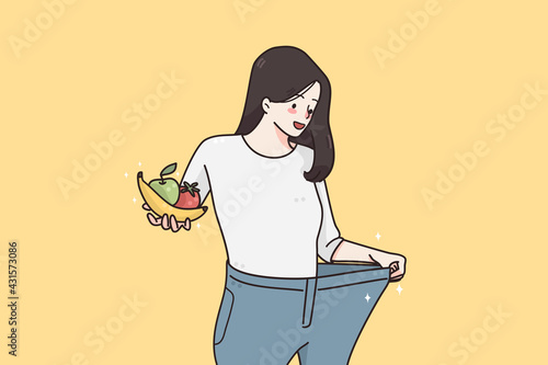 Weight loss and diet concept. Happy smiling woman in oversized jeans standing holding fresh fruits and vegetables showing weight loss results vector illustration 