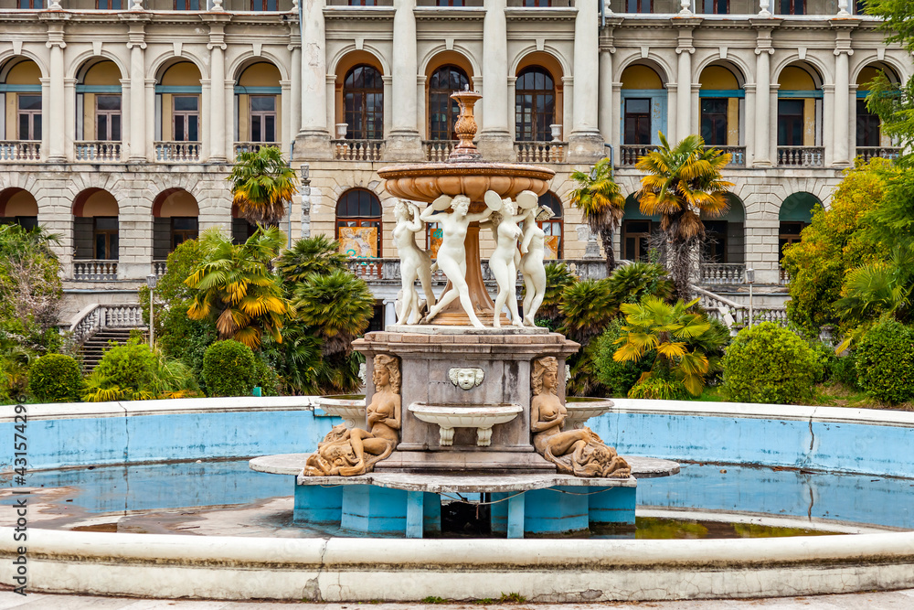 Naklejka premium Sochi, Russia, April 13, 2021. Fragment of the facade of the main building of the abandoned Ordzhonikidze sanatorium, historical and cultural landmark. Fountain 