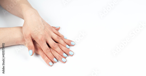 Manicure. Female hands with turquoise manicure. On white background.