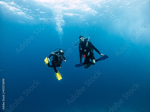 Tow divers underwater.