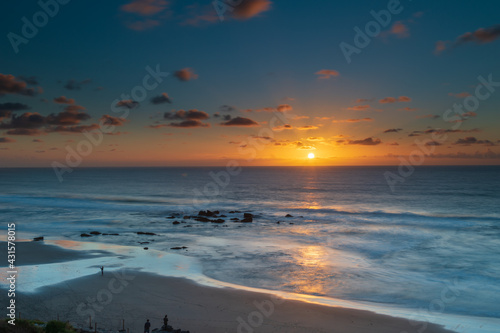 Beautiful sunset at Playa La Pared, Fuerteventura, Spain. Thanks to its perfect tides, the beach is famous by watersport fans and surfers. It is shallow at low tide; the water is cold.