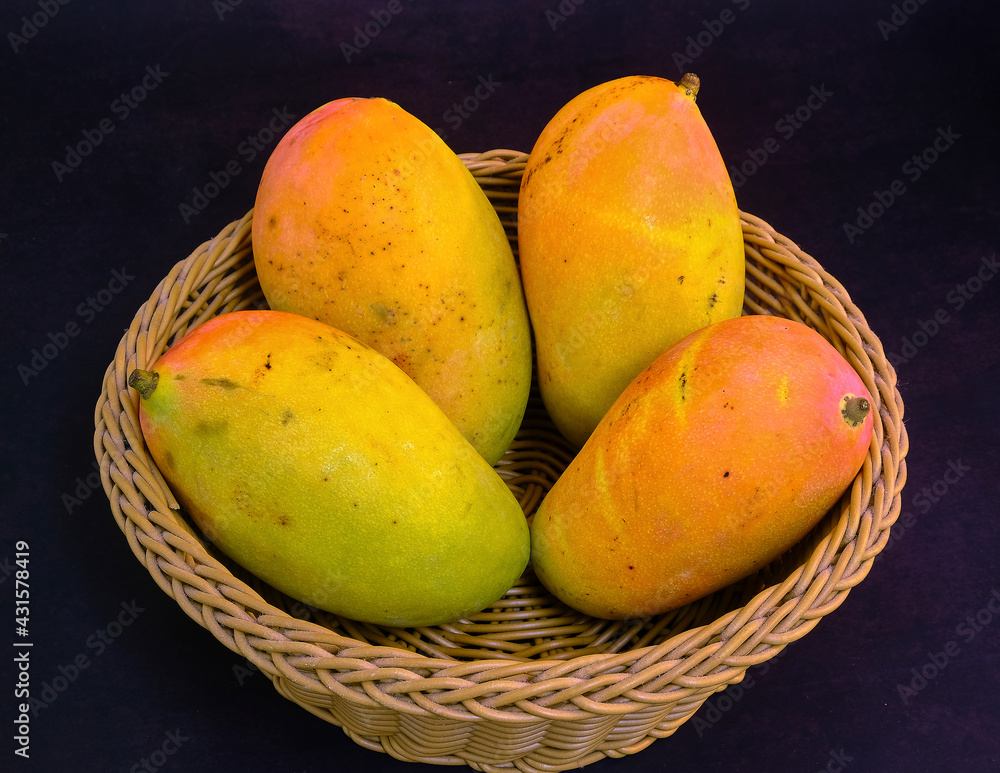 Fresh ripe mango on basket. Juicy fruits background. Healthy eating, Fruit juice shop. 
