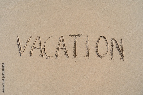 Vacation inscription on summer sandy beach. Leisure and adventure concept