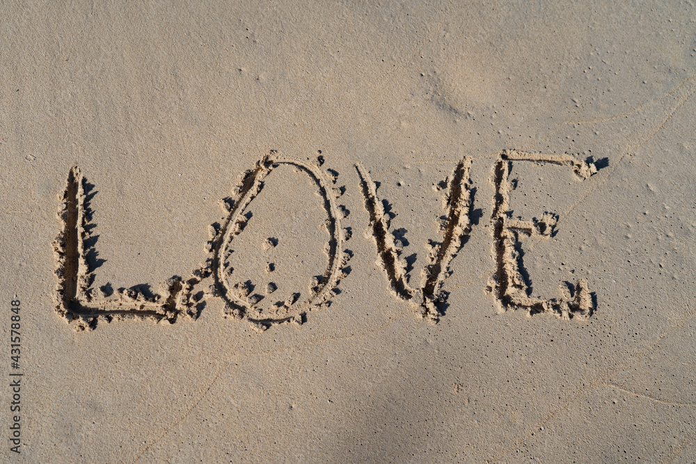 Fototapeta premium LOVE inscription on summer sandy beach. Relation ship and togetherness concept 