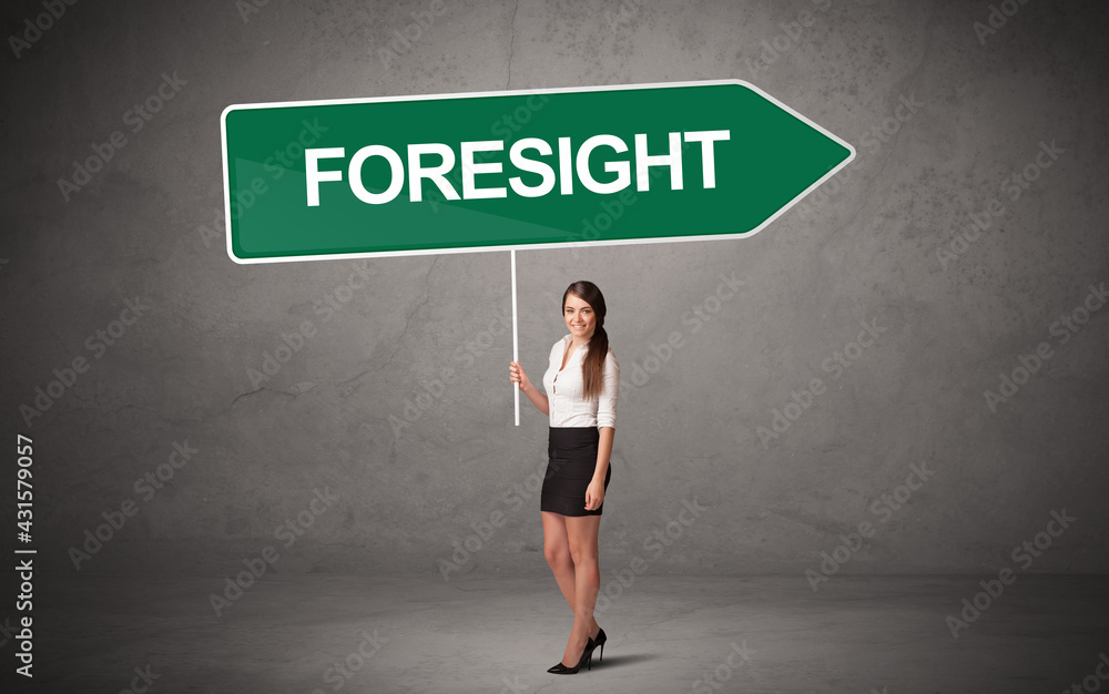 Young business person in casual holding road sign Young business person in casual holding road sign