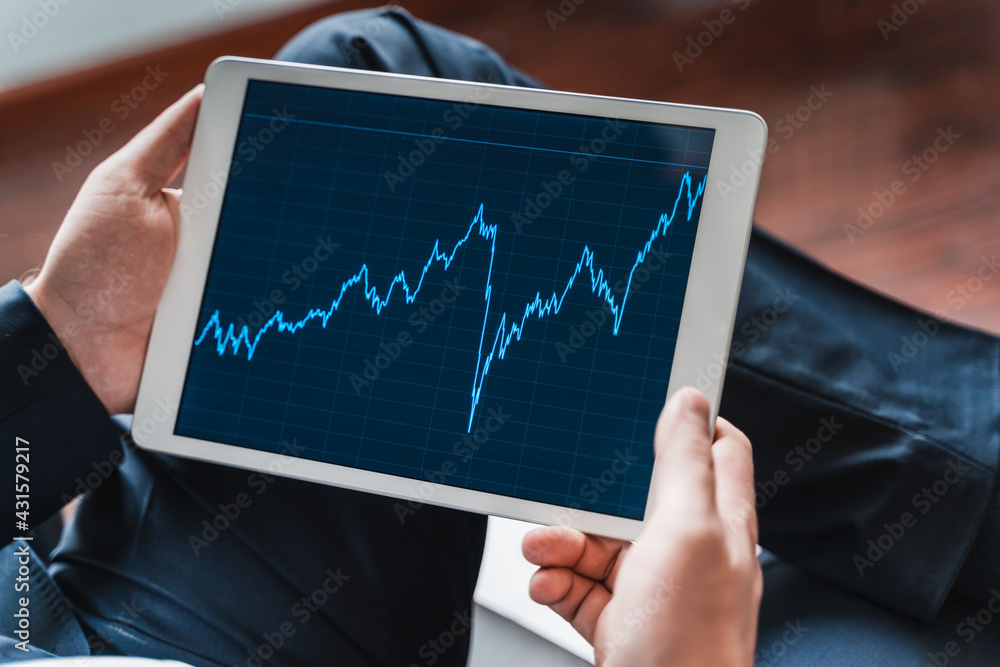 Businessman, investor,trader analyzing,looking at chart of stock prices in tablet. CEO,general manager.Bank investment.Finance company,hedge fund.Japanese candlestick,diagram Businessman, investor,trader analyzing,looking at chart of stock prices in tablet. CEO,general manager.Bank investment.Finance company,hedge fund.Japanese candlestick,diagram