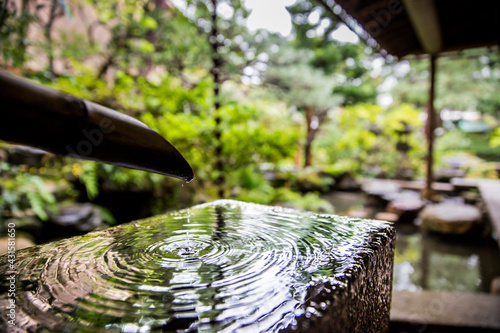 Bamboo natural spring water feature in the Japanese zen garden of the Nomura samurai clan house, Kanazawa, Japan. © Red Pagoda