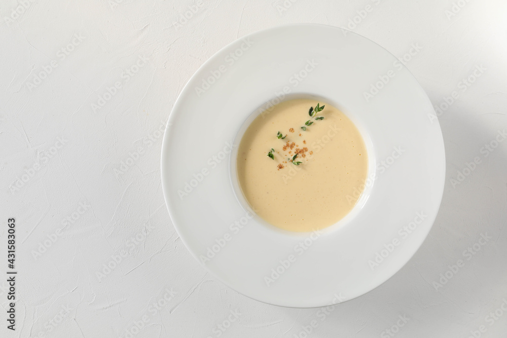 Traditional Italian egg soup ginestrata with spices - nutmeg, thyme, and cinnamon from Tuscany - top view with copy space Traditional Italian egg soup ginestrata with spices - nutmeg, thyme, and cinnamon from Tuscany - top view with copy space