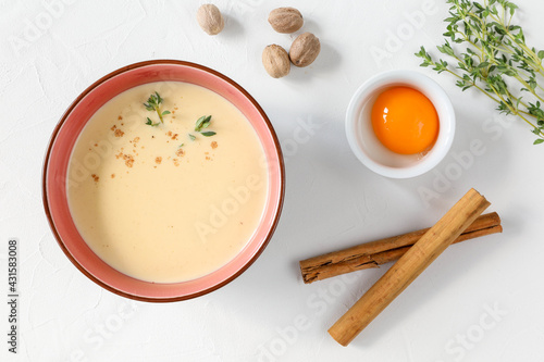 Italian chicken soup with wine, egg and ingredients - yolk, thyme, nutmeg and cinnamon photo