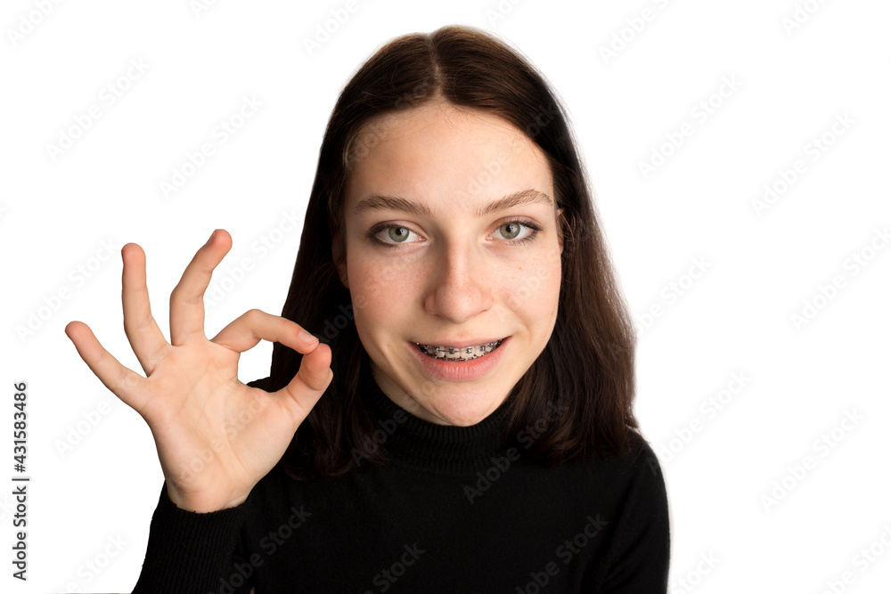 Orthodontic treatment. Dental care concept. Smiling teenage girl with braces. Metal braces close-up on the teeth. Orthodontic treatment. Dental care concept. Smiling teenage girl with braces. Metal braces close-up on the teeth.