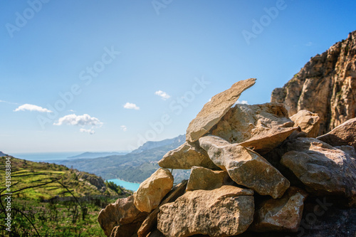 Small pile of stones on a rock, and with a natural landscape in the background.  © MiguelAngel
