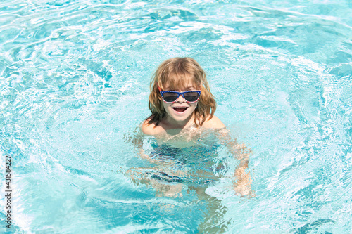 Kids summer vacation. Activities on pool. Having fun at aquapark. Kid swimming in water.