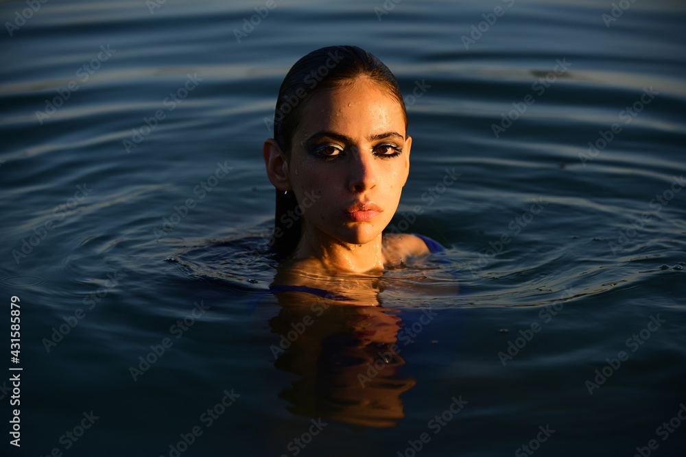 Sensual girl in water. Beauty woman. Fashion portrait. Summer beach.
