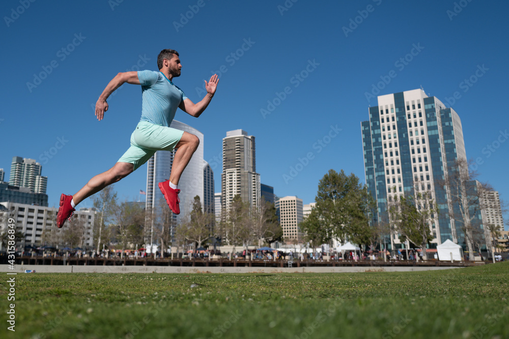 Full length of healthy man running and sprinting outdoors. Male sexy runner. Sport and healthy lifestyle.