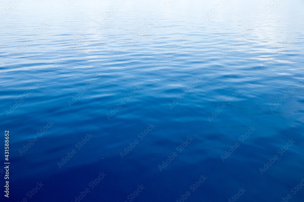 Blue water with sun reflections Blue water with sun reflections
