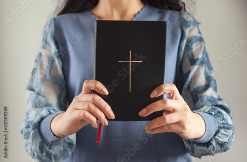 young prayer woman holding Bible