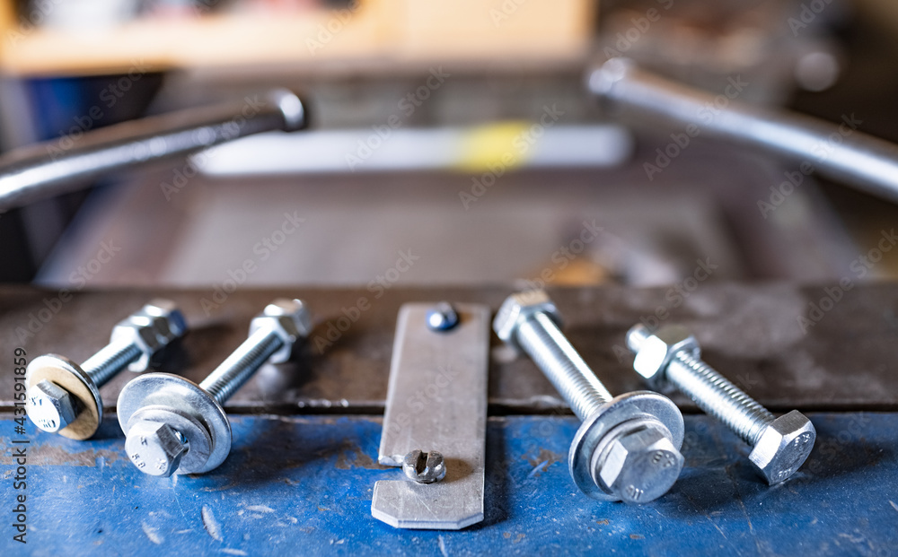 Metal chrome bolts and nuts on manual flexible massive machine Metal chrome bolts and nuts on manual flexible massive machine