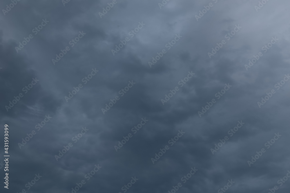Evening dark blue rainy sky with clouds. Cloudy weather with overhanging rain. Heavy clouds