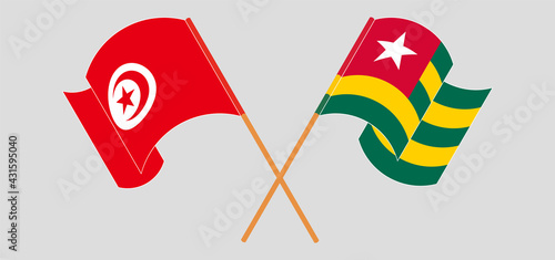 Crossed and waving flags of Tunisia and Togo