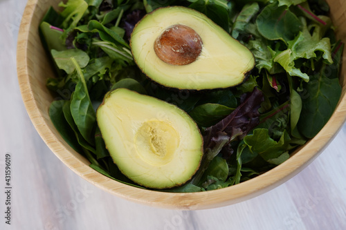 Fresh green organic avocado with salad in a plate 