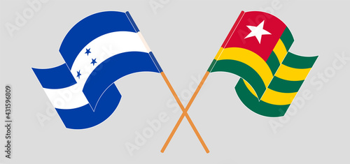 Crossed and waving flags of Honduras and Togo